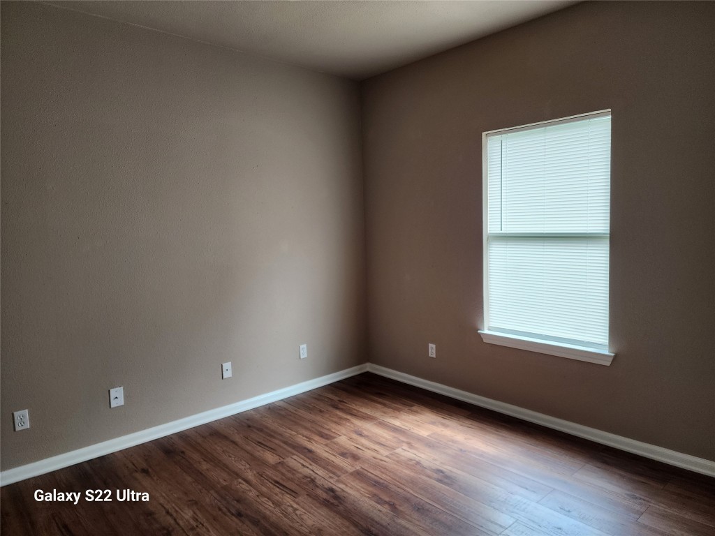 1926 Wavell Street Houston, TX 77088 - Photo 19 of 19 an empty room with wooden floor and windows