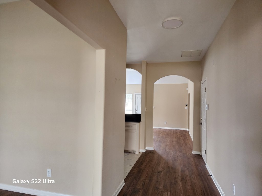 1926 Wavell Street Houston, TX 77088 - Photo 5 of 19 a view of a hallway with wooden floor and a bathroom