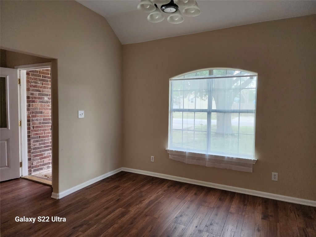 1926 Wavell Street Houston, TX 77088 - Photo 7 of 19 an empty room with wooden floor and windows
