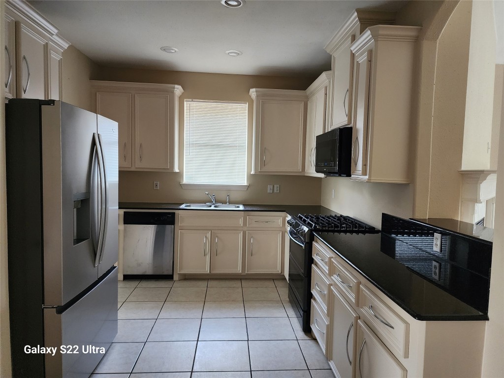 1926 Wavell Street Houston, TX 77088 - Photo 8 of 19 a kitchen with a sink a refrigerator and cabinets