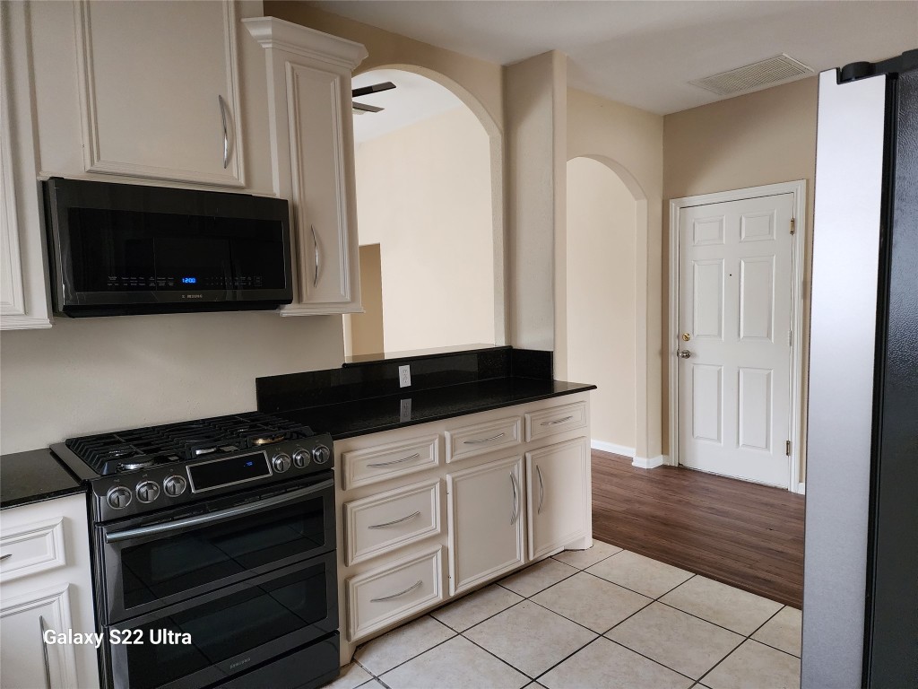 1926 Wavell Street Houston, TX 77088 - Photo 9 of 19 a kitchen with granite countertop a stove and a microwave