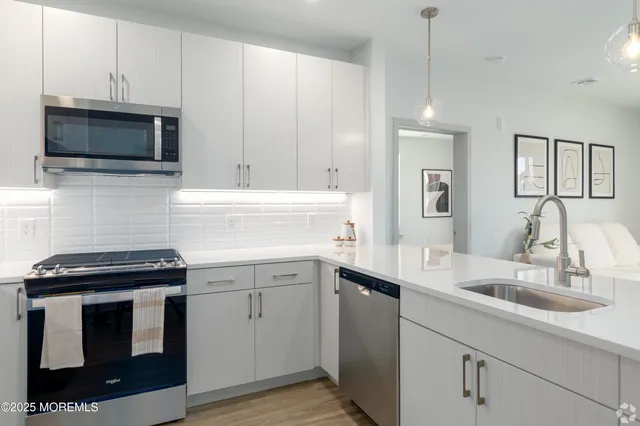 a kitchen with a sink stove and microwave