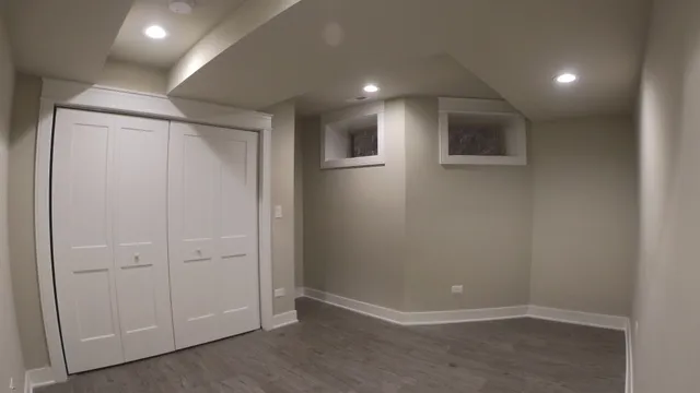 an empty room with wooden floor and closet