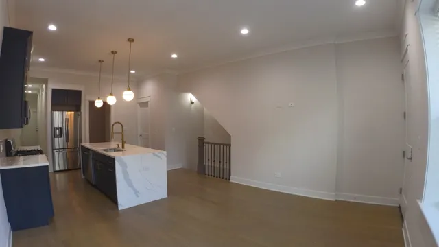 a view of a kitchen with a sink and cabinets