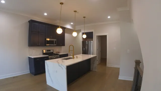 a kitchen with a sink a counter top space and cabinets
