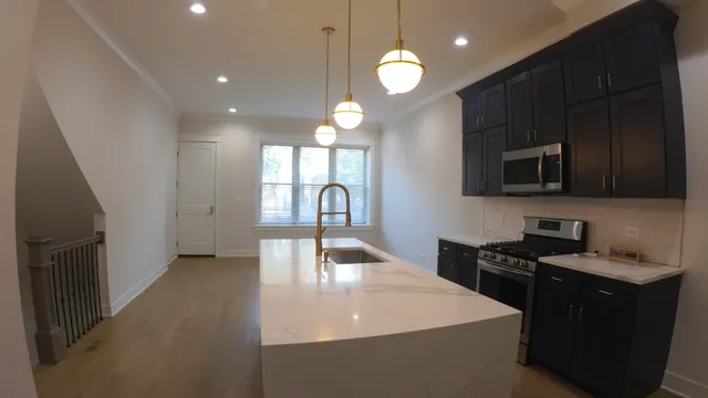 a kitchen with a sink a stove and cabinets