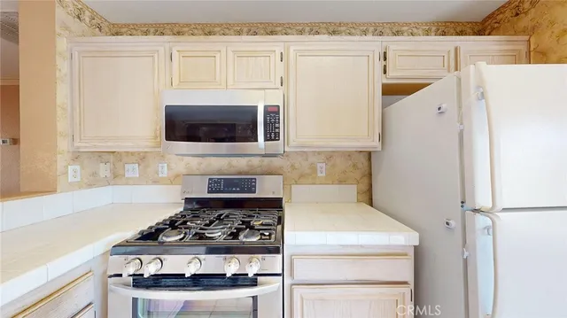 a kitchen with cabinets and appliances