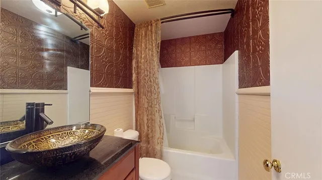 a living room with furniture and a lamp