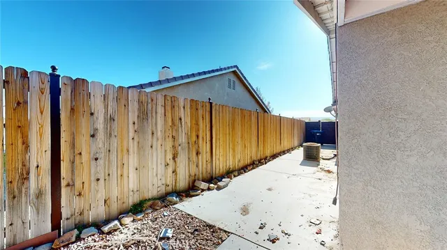 a view of a house with a yard and potted plants