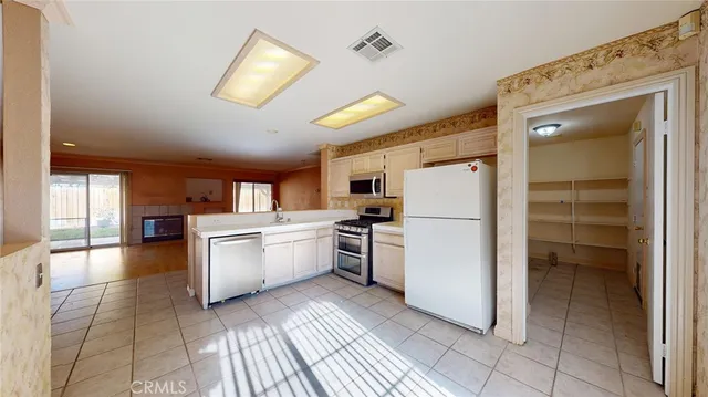 a kitchen with a refrigerator and a stove