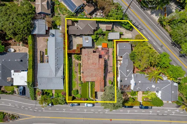 a aerial view of multi story residential apartment building with yard