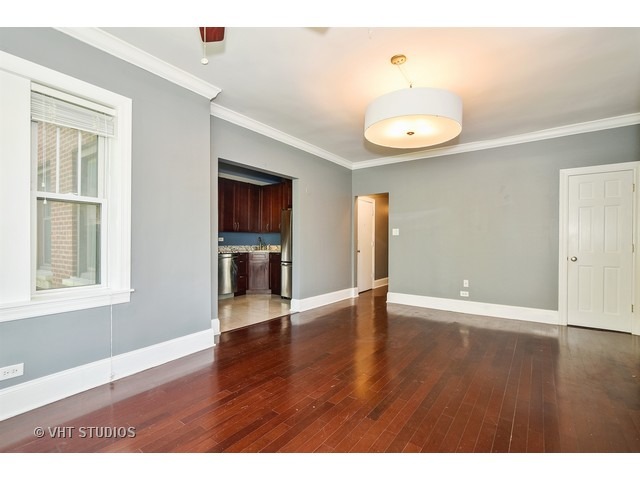 647 West Sheridan Road, Unit 4E Chicago, IL 60613 - Photo 3 of 10 a view of an empty room with wooden floor and a window