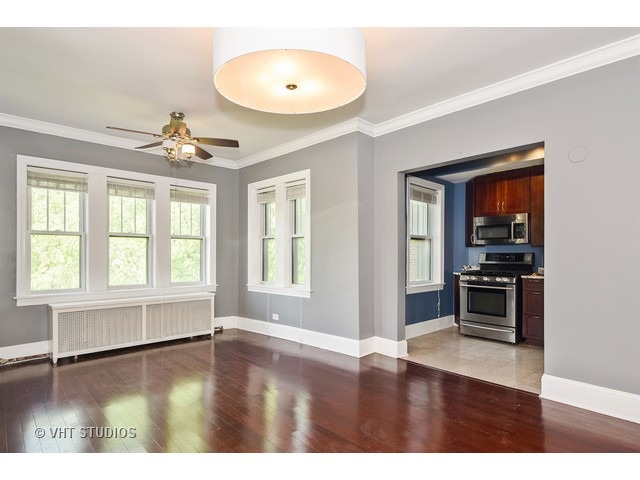 647 West Sheridan Road, Unit 4E Chicago, IL 60613 - Photo 5 of 10 an empty room with wooden floor and windows