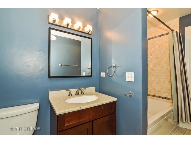 647 West Sheridan Road, Unit 4E Chicago, IL 60613 - Photo 8 of 10 a bathroom with a sink vanity and a mirror