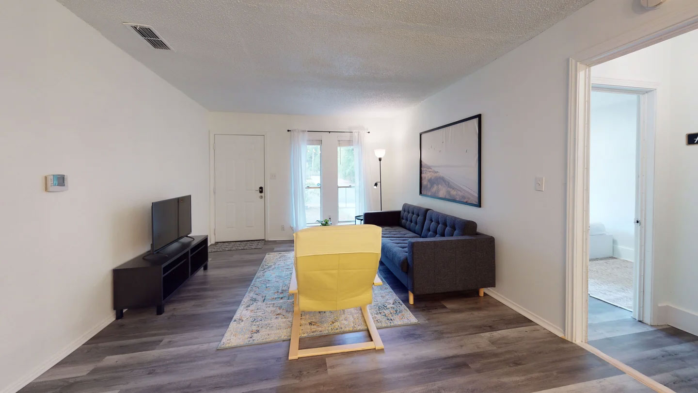 1109 Gardner Cove Austin, TX 78721 - Photo 4 of 13 Clean lines and wood-look flooring enhance this inviting living space.