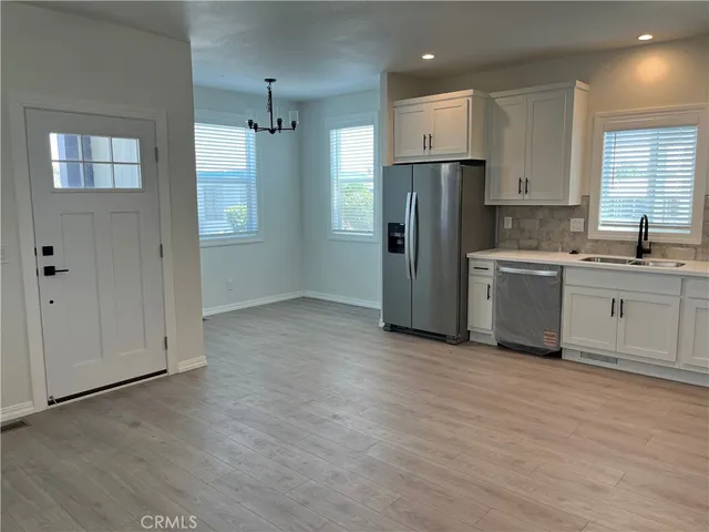 a kitchen with stainless steel appliances granite countertop a refrigerator and a sink