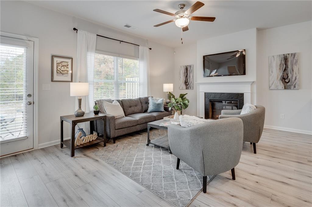 7443 Knoll Hollow Road Lithonia, GA 30058 - Photo 13 of 46 a living room with furniture a window and a fireplace