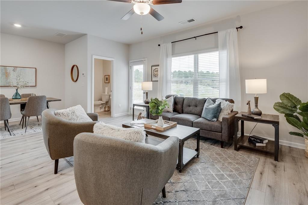 7443 Knoll Hollow Road Lithonia, GA 30058 - Photo 16 of 46 a living room with furniture and a large window
