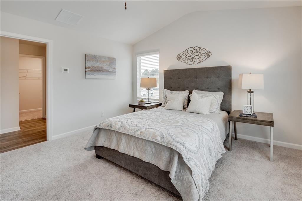 7443 Knoll Hollow Road Lithonia, GA 30058 - Photo 27 of 46 a bedroom with a bed and window