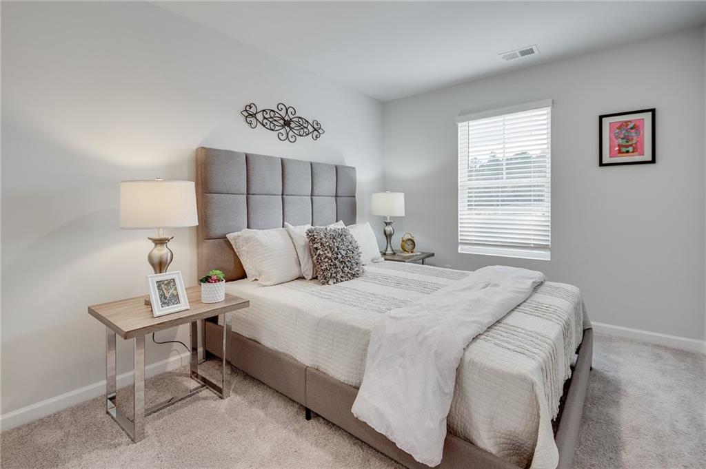 7443 Knoll Hollow Road Lithonia, GA 30058 - Photo 38 of 46 a bedroom with a bed and window