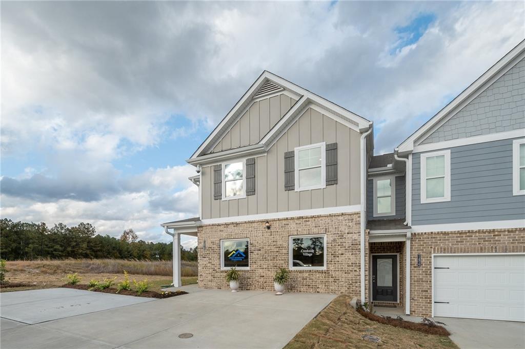7443 Knoll Hollow Road Lithonia, GA 30058 - Photo 4 of 46 a front view of a house with a yard and garage