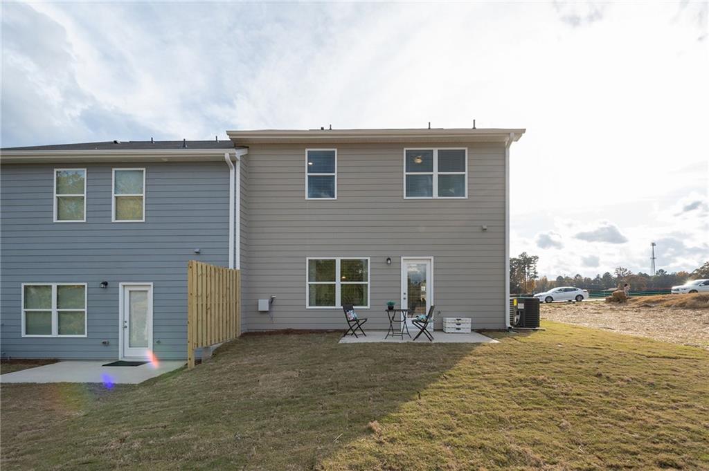 7443 Knoll Hollow Road Lithonia, GA 30058 - Photo 44 of 46 a view of a house with backyard and lake view