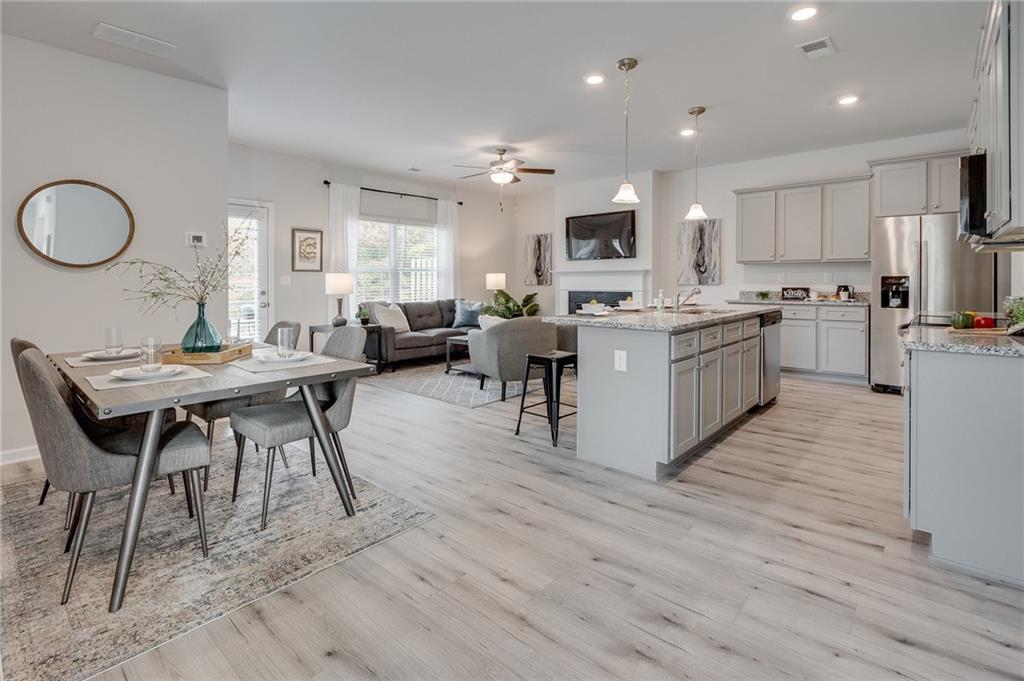 7443 Knoll Hollow Road Lithonia, GA 30058 - Photo 10 of 46 a view of kitchen with sink dining table and chairs