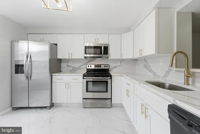 a kitchen with a refrigerator and a sink