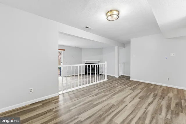 a view of a room with wooden floor
