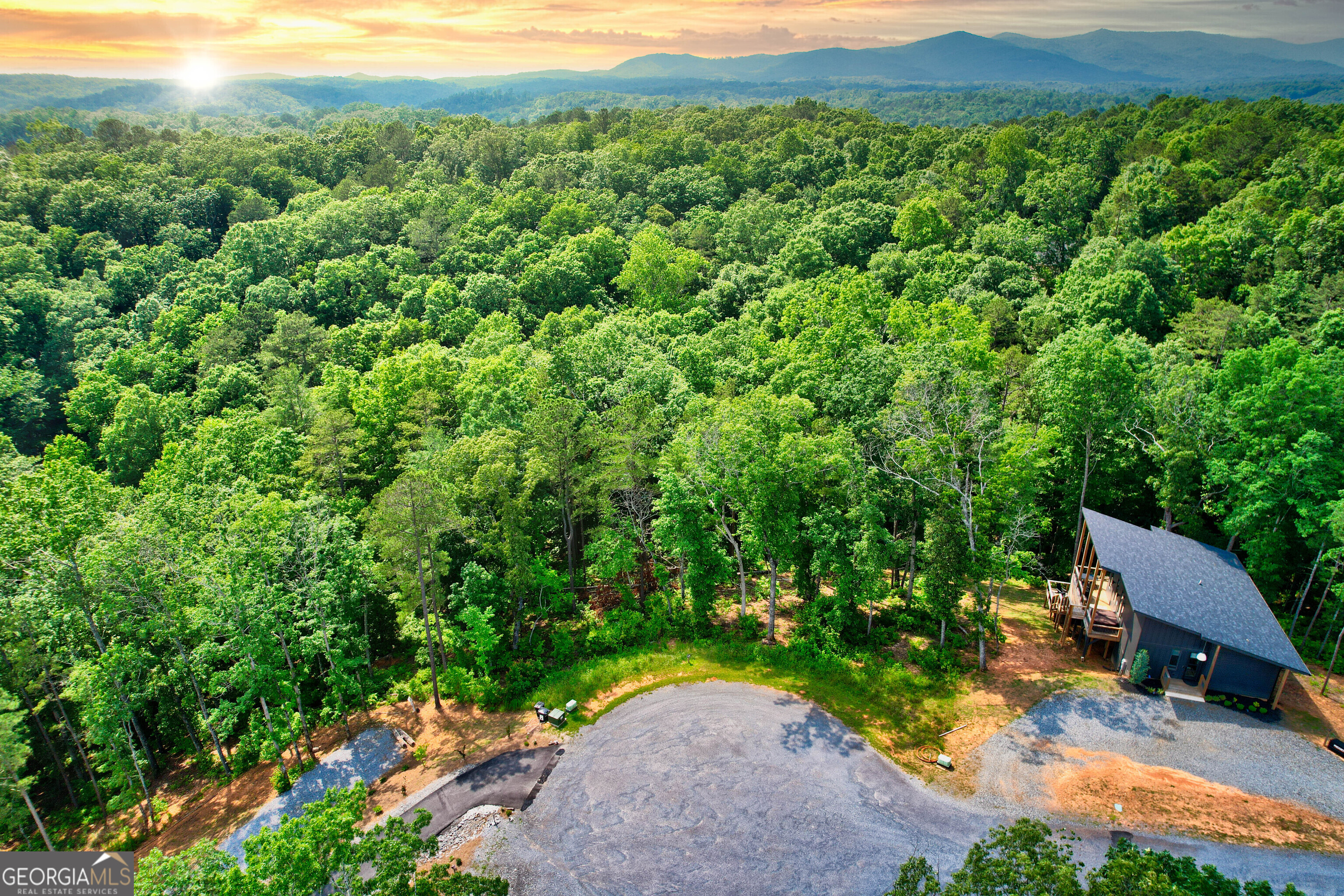 Lot 16 Lake Top Lane Ellijay, GA 30540 - Photo 17 of 17 a view of a lush green outdoor space with a house in the background