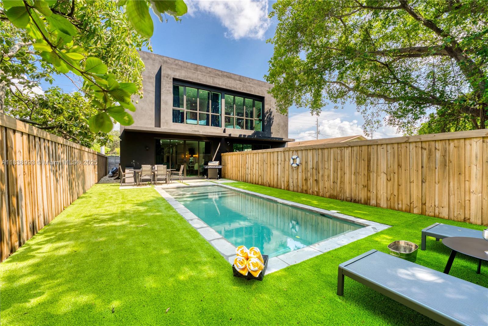 a swimming pool with outdoor seating and yard
