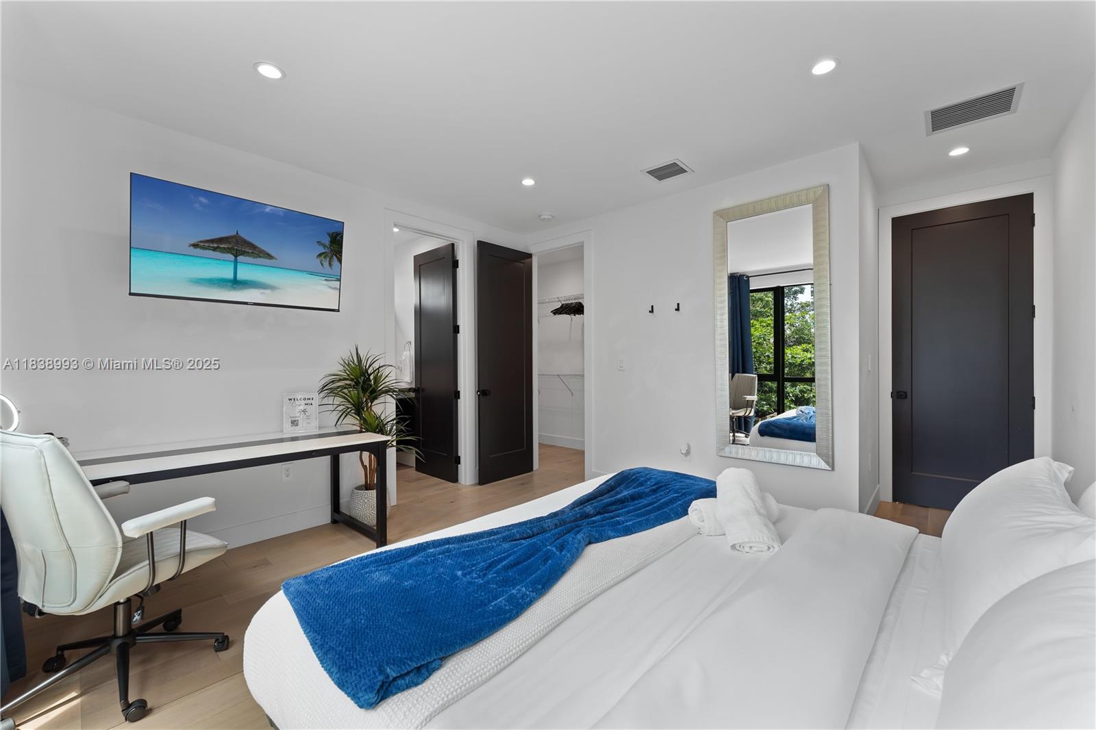 58 Northwest 52nd Street, Unit 58 Miami, FL 33127 - Photo 11 of 21 a spacious bedroom with a bed and a desk