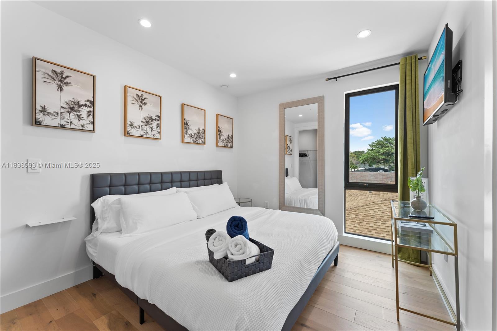 58 Northwest 52nd Street, Unit 58 Miami, FL 33127 - Photo 14 of 21 a bedroom with a bed and a refrigerator