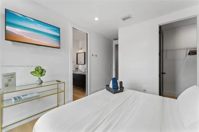 a bedroom with a bed and hallway