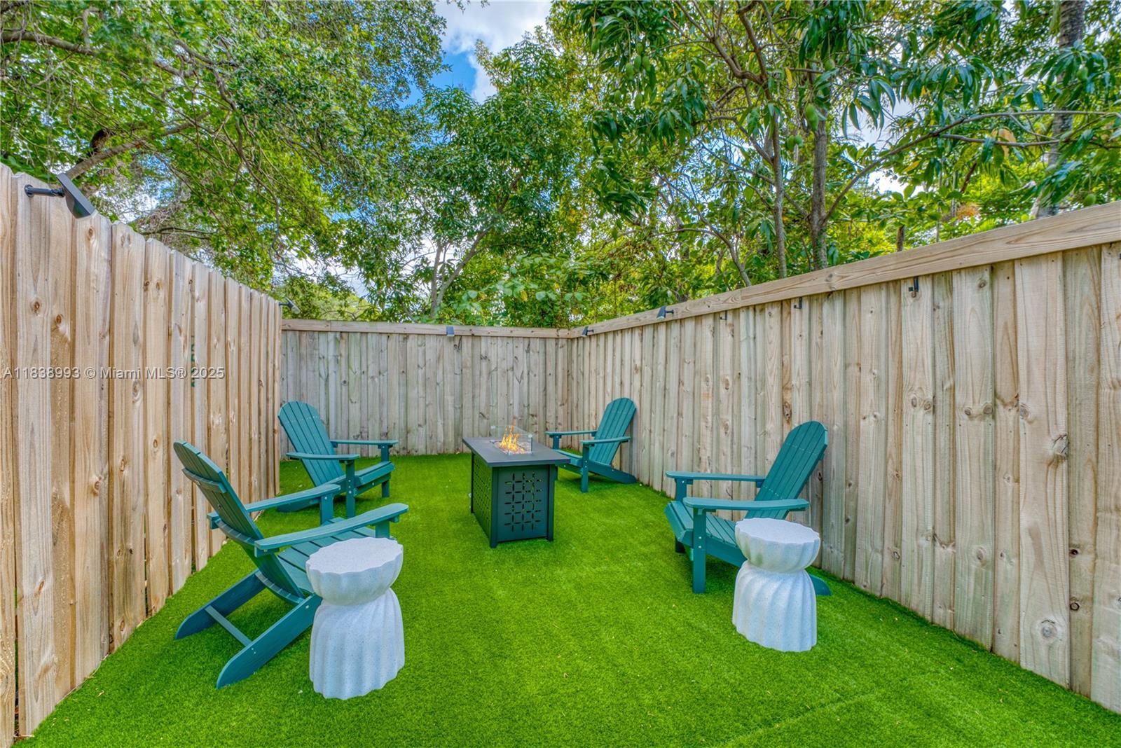 58 Northwest 52nd Street, Unit 58 Miami, FL 33127 - Photo 20 of 21 a backyard of a house with table and chairs