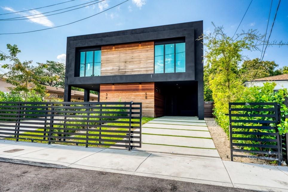 58 Northwest 52nd Street, Unit 58 Miami, FL 33127 - Photo 2 of 21 a front view of a house with a garden