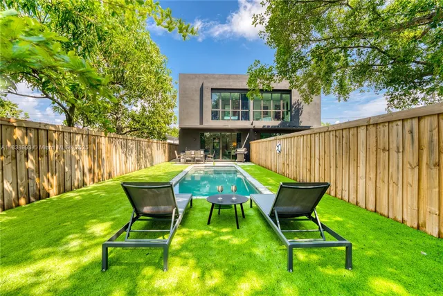 a view of a chairs and backyard with a slide