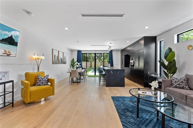 a living room with furniture wooden floor and a flat screen tv
