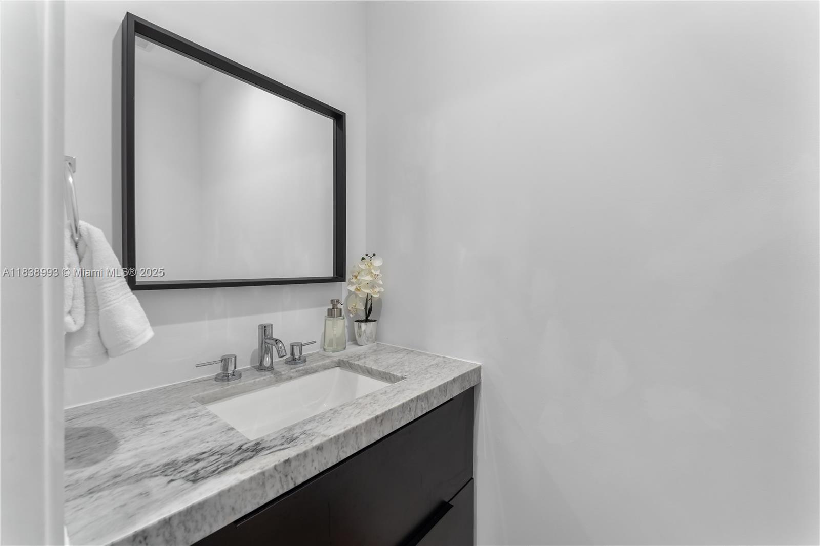 58 Northwest 52nd Street, Unit 58 Miami, FL 33127 - Photo 8 of 21 a bathroom with a granite countertop sink and a mirror