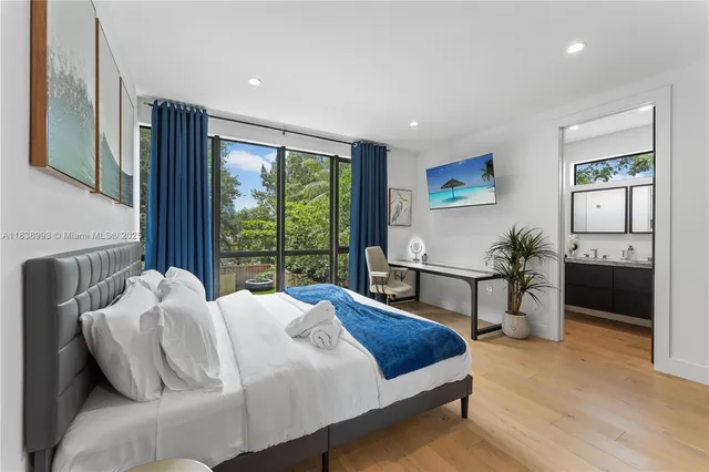 a bedroom with a bed and a large window