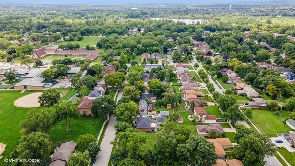 a view of a city with lush green forest
