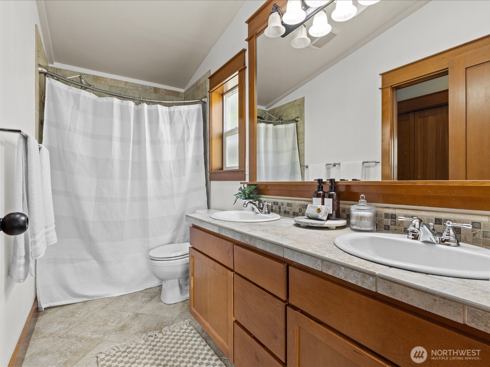 3018 Southwest Hinds Street Seattle, WA 98126 - Photo 20 of 27 a bathroom with a sink a toilet a mirror and shower