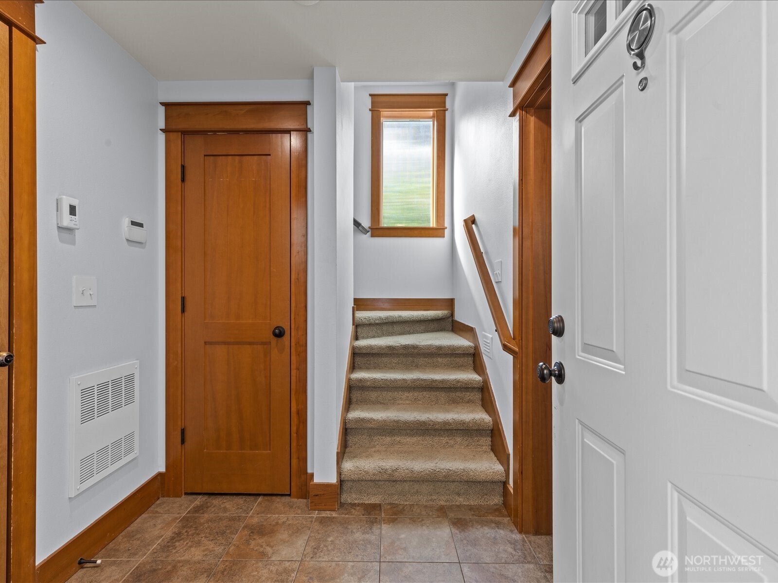 3018 Southwest Hinds Street Seattle, WA 98126 - Photo 3 of 27 a view of a hallway with wooden floor and entryway