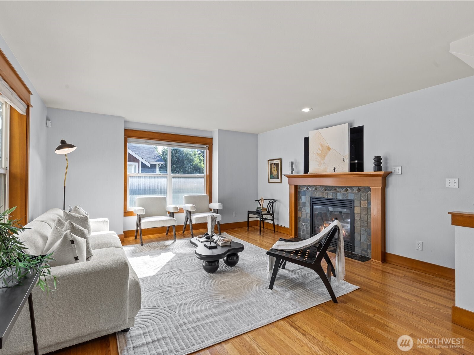3018 Southwest Hinds Street Seattle, WA 98126 - Photo 7 of 27 a living room with furniture a rug and a fireplace