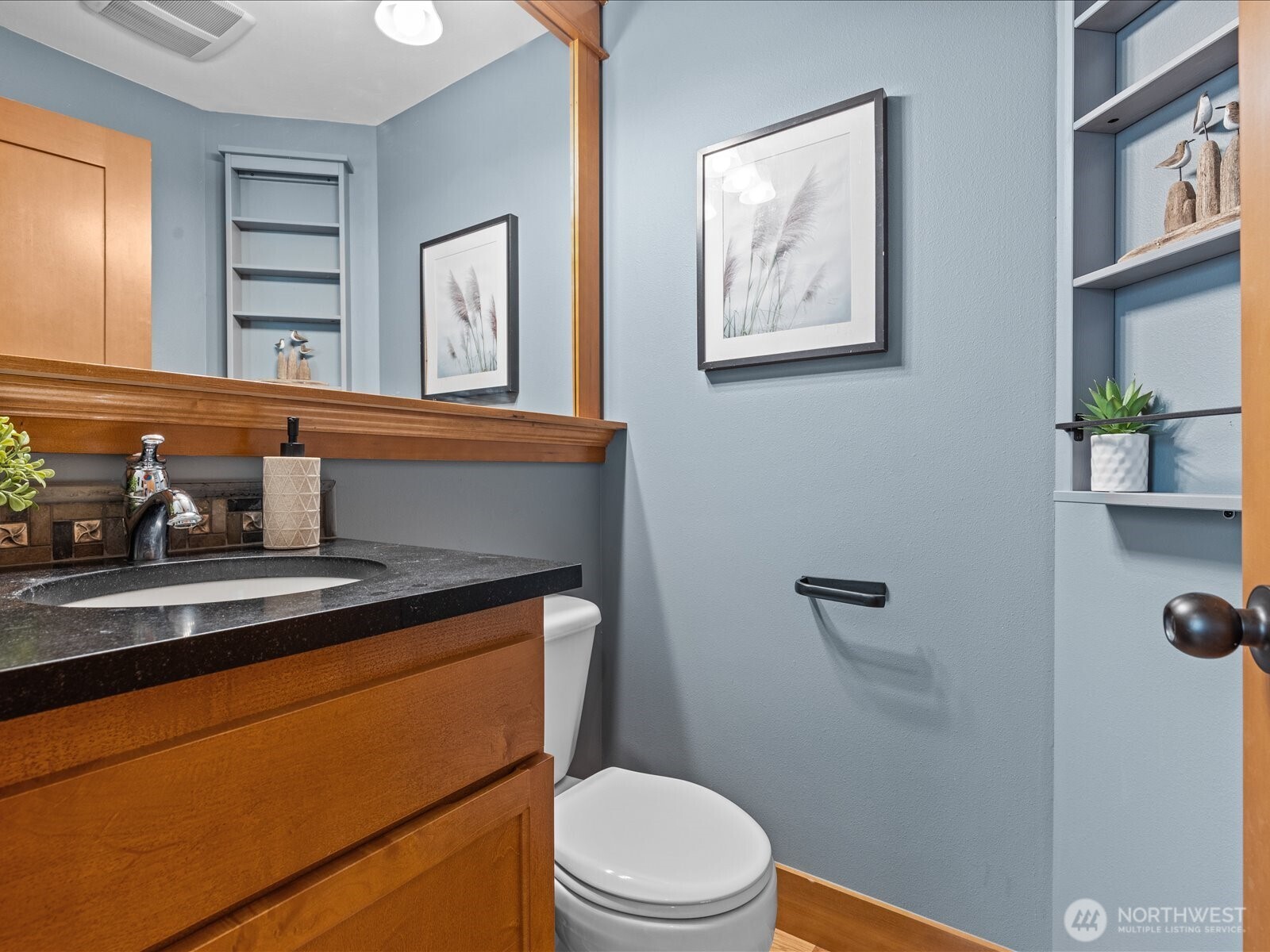 3018 Southwest Hinds Street Seattle, WA 98126 - Photo 9 of 27 a bathroom with a toilet a sink and mirror