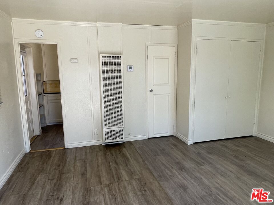 351 Temple Avenue, Unit E Long Beach, CA 90814 - Photo 5 of 22 a view of an empty room with closet and wooden floor