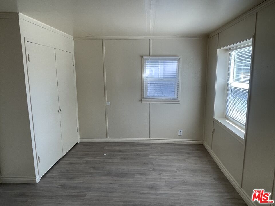 351 Temple Avenue, Unit E Long Beach, CA 90814 - Photo 7 of 22 a view of an empty room with wooden floor and a window