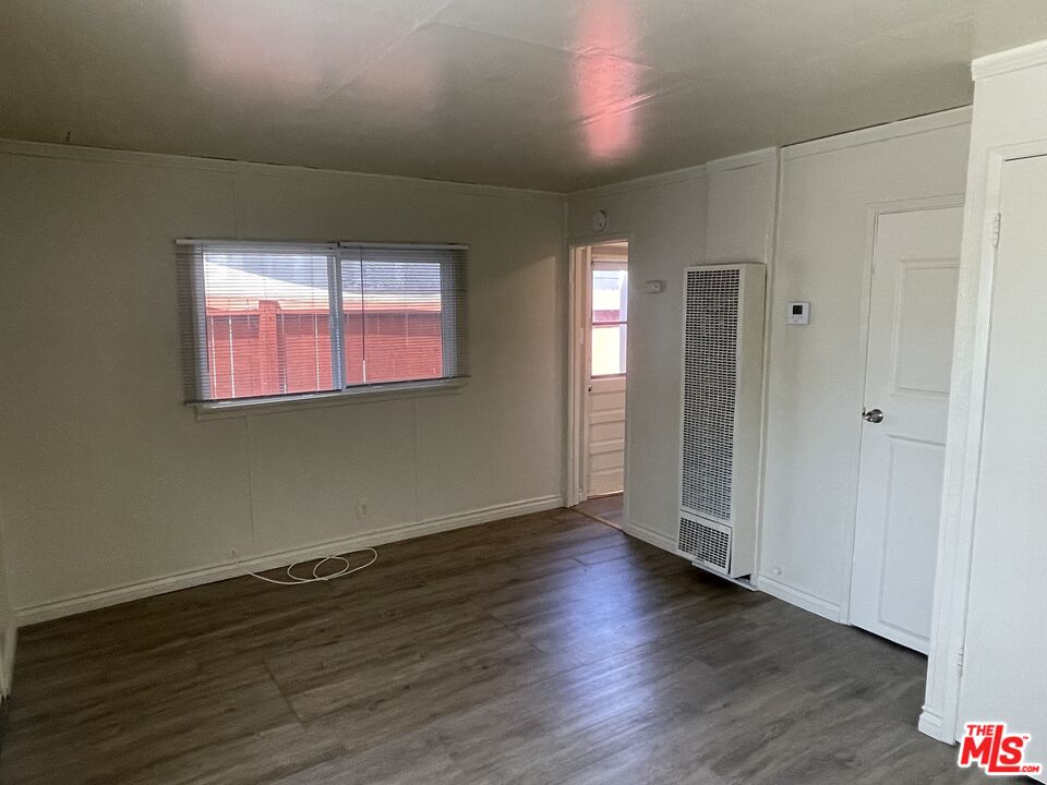 351 Temple Avenue, Unit E Long Beach, CA 90814 - Photo 8 of 22 an empty room with wooden floor and windows