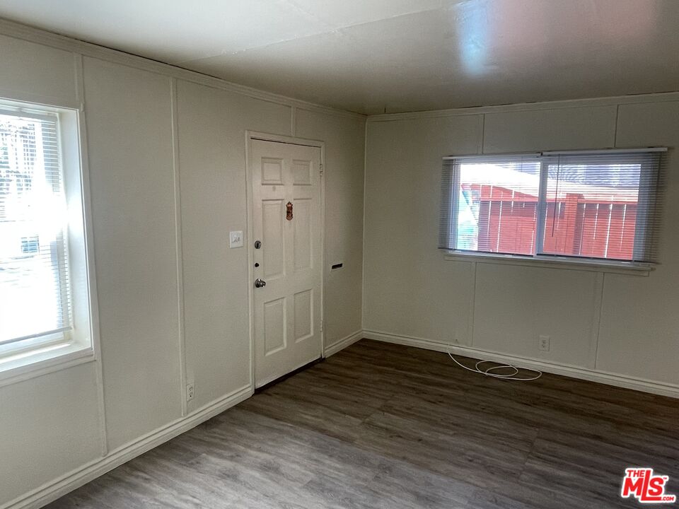 351 Temple Avenue, Unit E Long Beach, CA 90814 - Photo 9 of 22 an empty room with wooden floor and windows