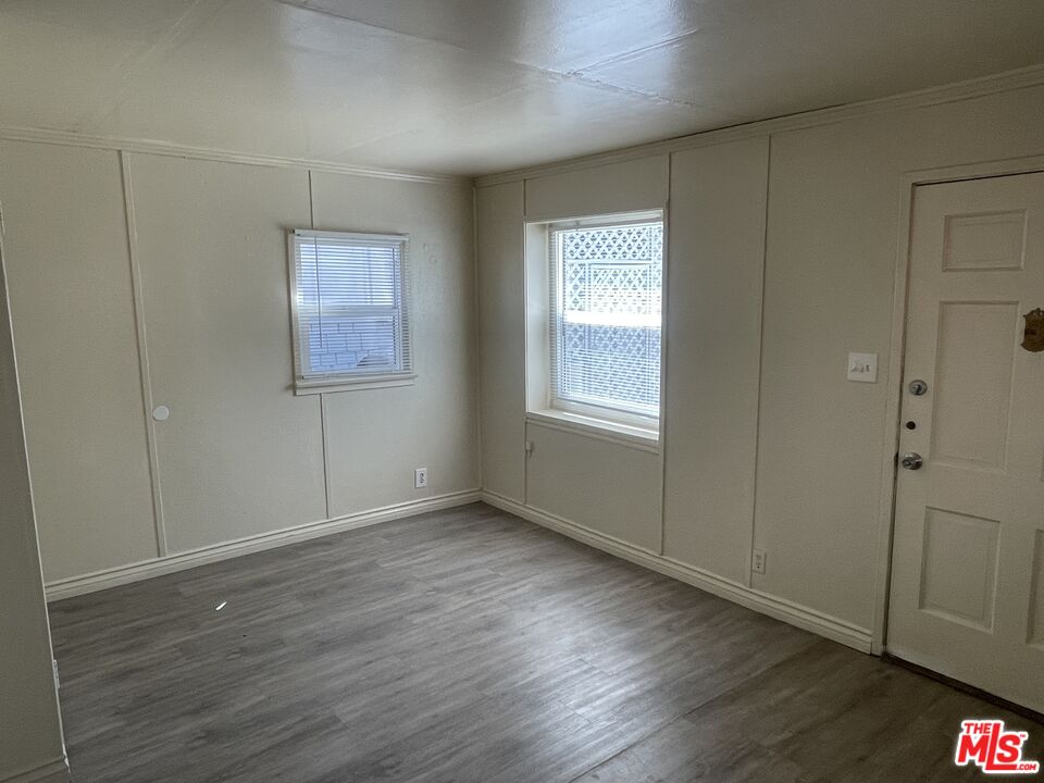 351 Temple Avenue, Unit E Long Beach, CA 90814 - Photo 10 of 22 a view of an empty room with wooden floor and a window